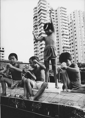 Migrant children playing with medical waste, Haikou.