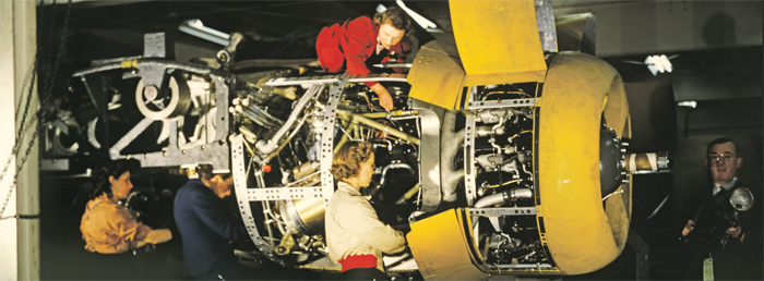 Workers at the Willow Run manufacturing plant assemble a plane engine, ca. 1942.