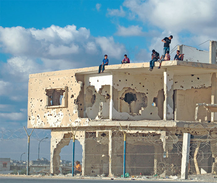 Children atop a bullet-riddled building in Gaza, 2011.