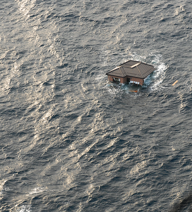 A home floats in the Pacific Ocean near Sendai, Japan, March 13, 2011. Mass Communication Specialist 3rd Class Dylan McCord/Flickr.