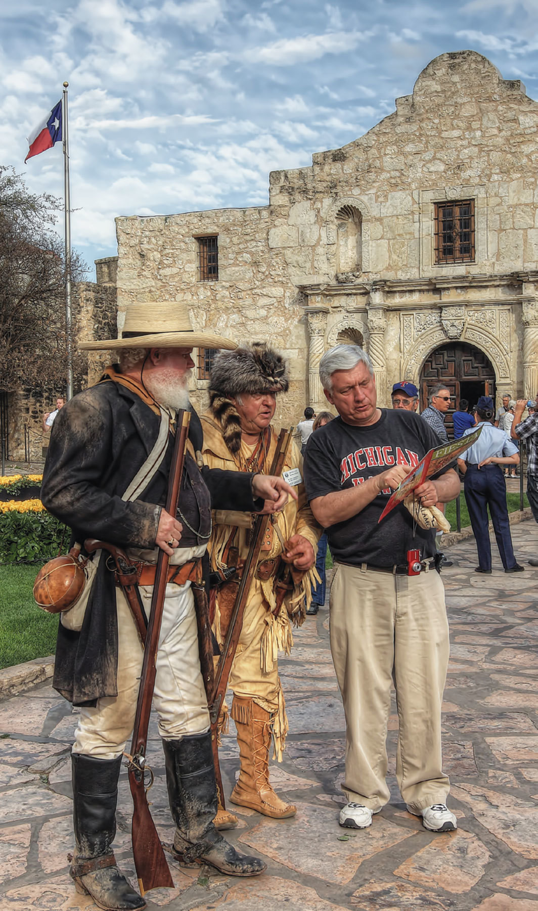 A tourist asks Davy Crockett and James Bowie impersonators for directions during the 175th anniversary of the Battle of the Alamo, San Antonio, Texas, March 4, 2011.