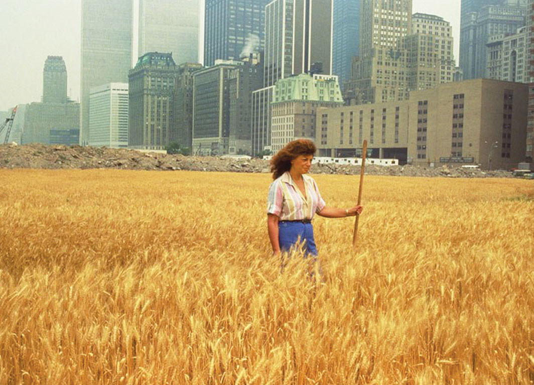 Agnes Denes with her Wheatfield: A Confrontation, 1982, New York. John McGrall; Courtesy the artist and Leslie Tonkonow Artworks + Projects