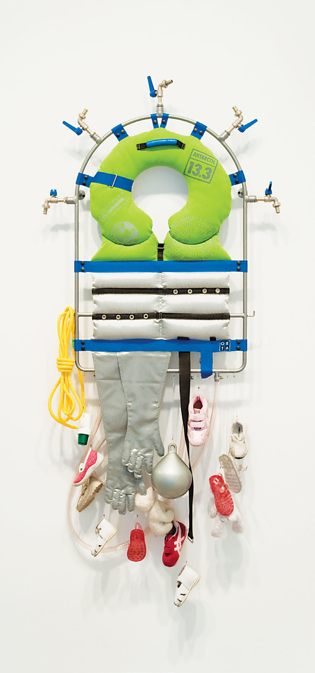 Lucy and Jorge Orta, Life Line – Survival Kit, 2008, steel frame, piping, taps, textiles, silk screen on fabric, webbing, shoes, float, warning light, rope, 59 × 31 1⁄2 × 5 7⁄8". Courtesy the artist and Jane Lombard Gallery
