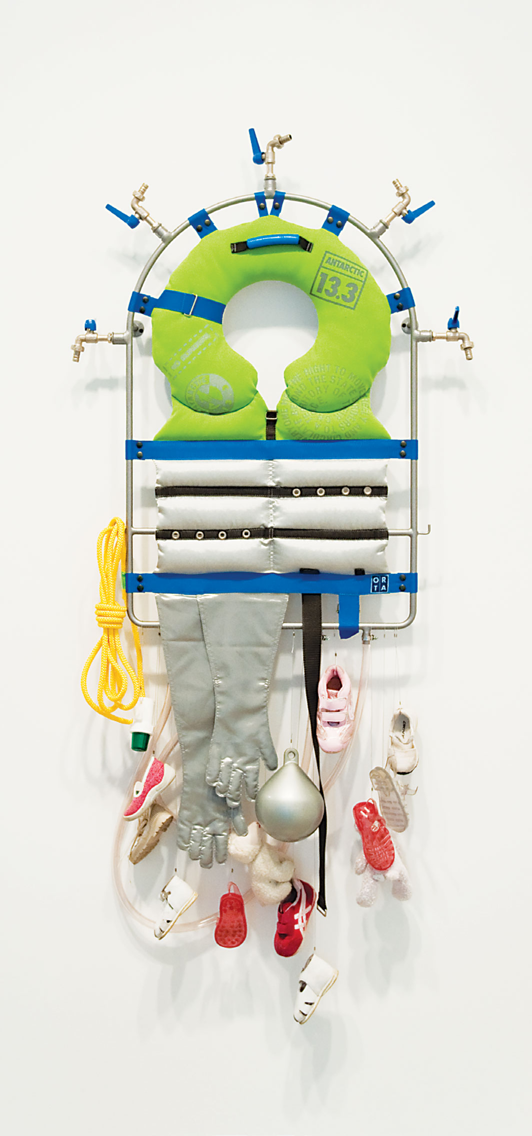 *Lucy and Jorge Orta, _Life Line – Survival Kit,_ 2008,* steel frame, piping, taps, textiles, silk screen on fabric, webbing, shoes, float, warning light, rope, 59 × 31 1⁄2 × 5 7⁄8". Courtesy the artist and Jane Lombard Gallery