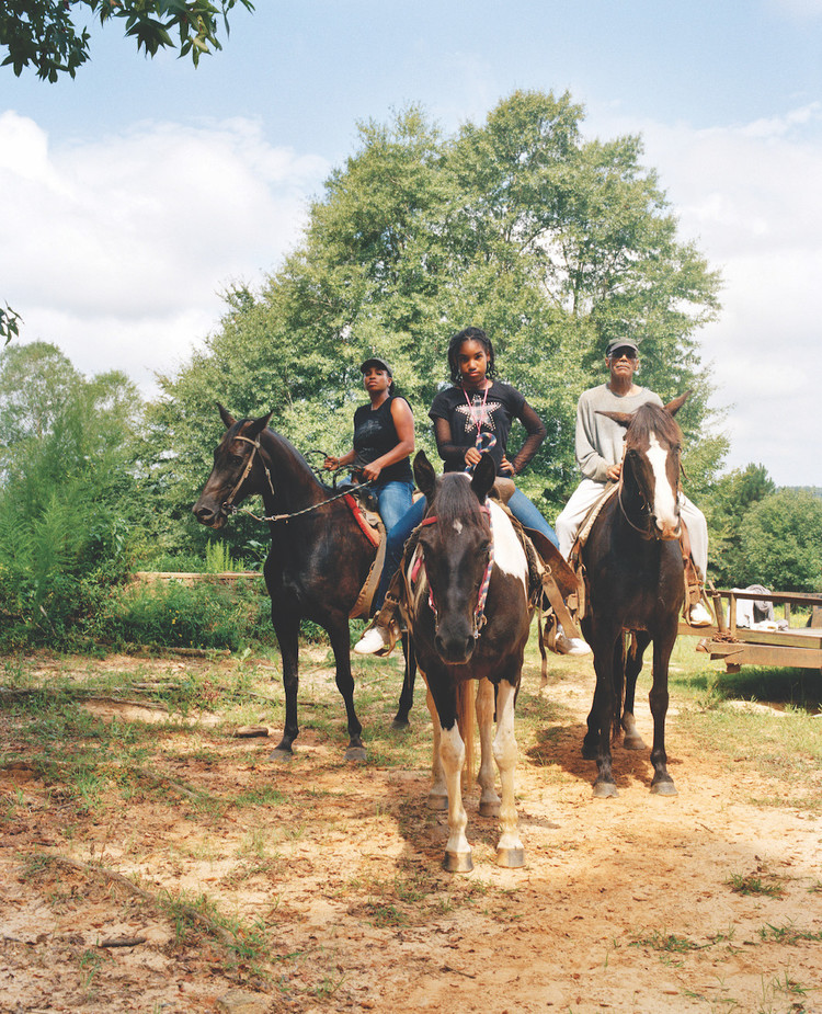 *LaToya Ruby Frazier, _Zion, Her Mother Shea, and Her Grandfather Mr. Smiley Riding on Their Tennessee Walking Horses, Mares, P.T. (P.T.’s Miss One Of A Kind), Dolly (Secretly), and Blue (Blue’s Royal Threat), Newton, Mississippi, 2017/19_, 2021,* ink-jet